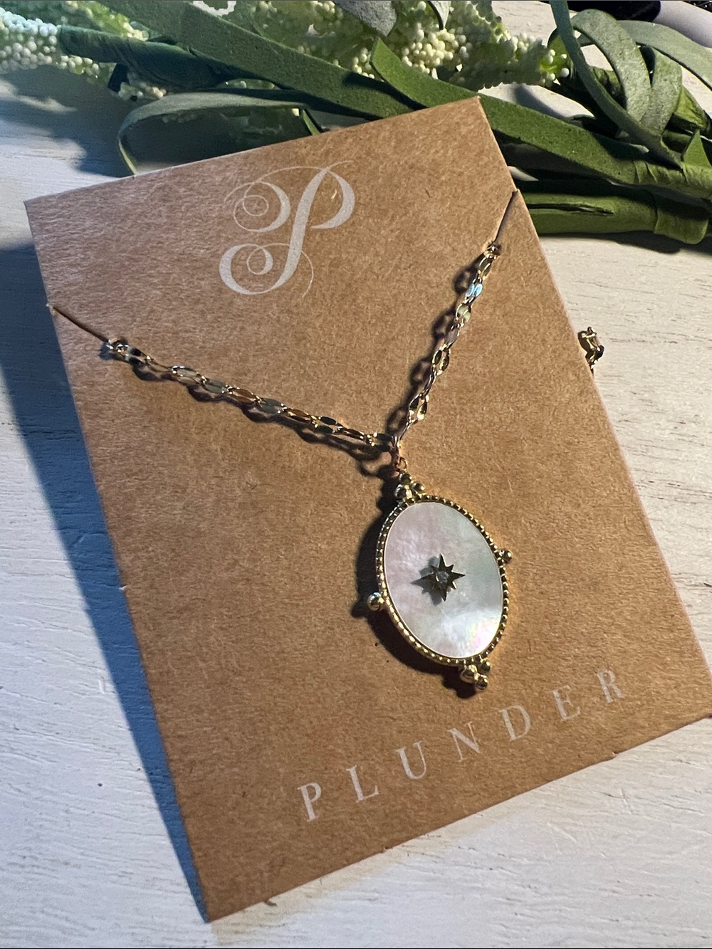 Plunder gold tone necklace with mother of pearl